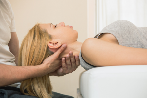 Woman getting a neck adjustment by a Sparks Chiropractor